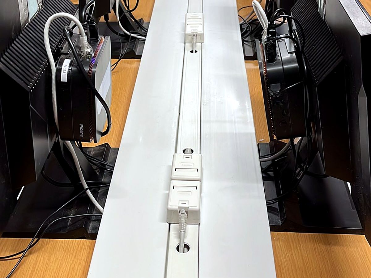 White trunking with network data points running along computer lab desks